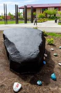 Large black rock facing campus commons